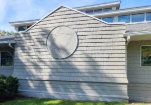 AFTER - Rotted shingles removed and replaced. Gutters added to channel water away from area.